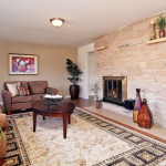 Stately fireplace accentuates this pleasant living room.