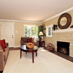 Light and bright entry into the living room warmed by the stone fireplace